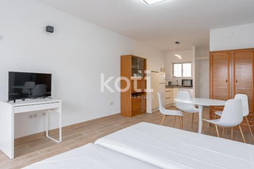 a white room with a bed and a table and chairs at Koti Rentals - Benavente Loft in Fuengirola