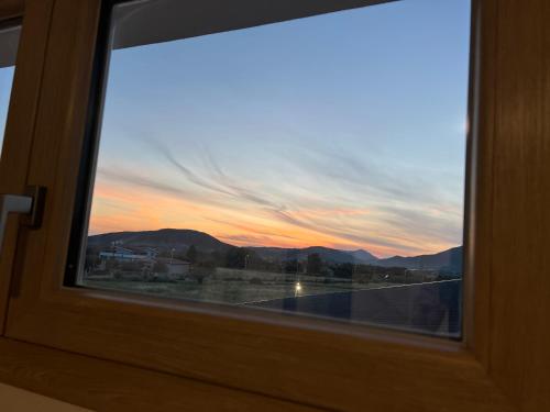 a view of a sunset through a window at Villa INN in Villaperuccio
