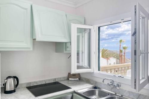 a kitchen with a sink and a window at Sa Luna in Arenal d'en Castell