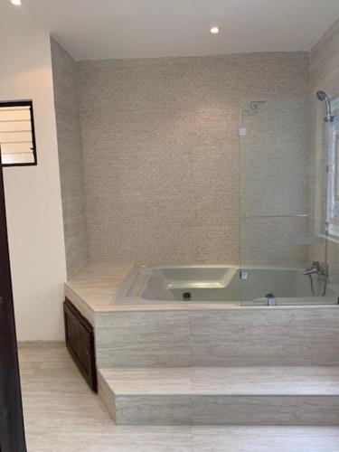 a bathroom with a tub and a sink at Luxury House near to Juan Sant. Airport, Alajuela. in Alajuela City