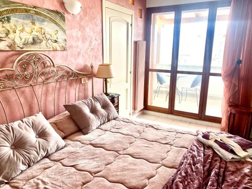 a bedroom with a large bed in front of a window at CasAzzurra in Ortona