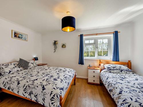 a bedroom with two beds and a window at 1 Bed in Westward Ho 46819 in Westward Ho