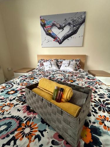 a bedroom with a bed with a heart painting on the wall at 82a Underwood Lane in Crewe