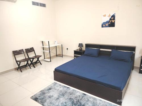 a bedroom with a bed and a table and chairs at New! Relaxing Family Home just 8 mins to waterfront in Sharjah