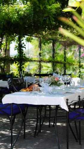 a table with a white table cloth on it with chairs at Hotel Sinuessa Terme in Mondragone