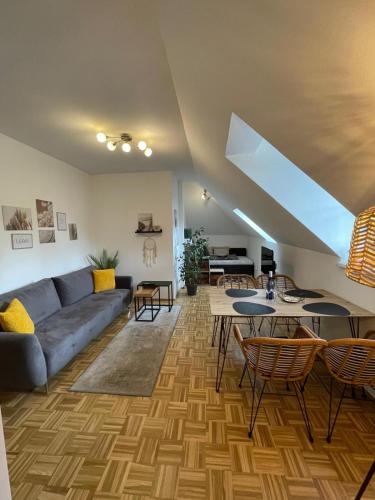 a living room with a couch and a table at BullsLiving Seeapartment 5 in Velden am Wörthersee