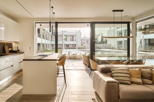 a kitchen and living room with a couch and a table at SalvatoreHomes - Pure Luxury in the Centre of Bardolino with Pool & Private Garden - Casa Olivia - a 5 Star Luxury Collection at Lake Garda in Bardolino