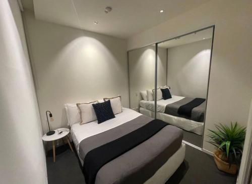 a bedroom with a large bed and a mirror at Walkerville Wonder - free wine in Broadview