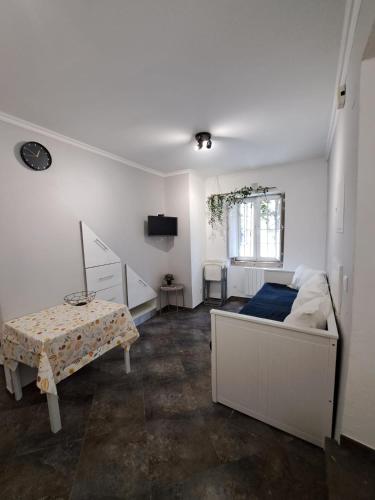 a bedroom with a bed and a table in it at Casa Cor de Rosa in Lisbon