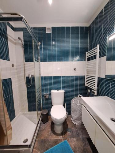 a bathroom with a toilet and a shower and a sink at Casa Cor de Rosa in Lisbon