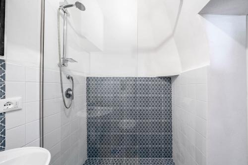 a bathroom with a shower and a toilet at Vico di Ostuni Apartments by Rentbeat in Ostuni