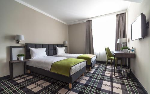 Postel nebo postele na pokoji v ubytování Hotel Impresja
