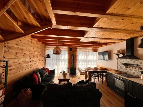 a living room with a couch and a table at Dom nad jeziorem in Borowy Młyn