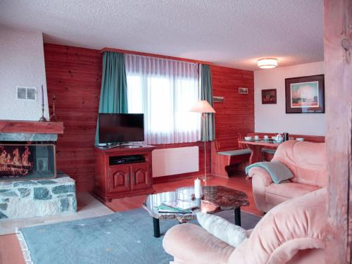 a living room with a couch and a fireplace at Apartment Ambassadeur 1 by Interhome in Villars-sur-Ollon