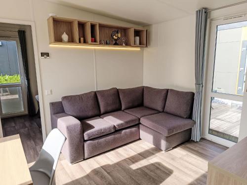 a living room with a couch and a table at Holiday Home Tiny Haus Sonnendeck by Interhome in Beilngries