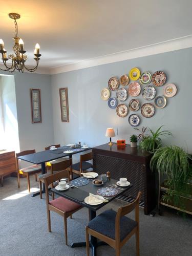a dining room with plates on the wall at Leven House Bed and Breakfast in Crieff