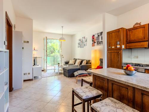 a kitchen and living room with a couch at Apartment Casa sul Lario by Interhome in Fiumelatte