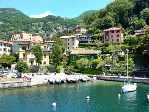 a small town with boats in a body of water at Apartment Casa sul Lario by Interhome in Fiumelatte