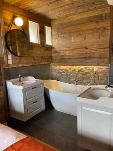een badkamer met een bad, een wastafel en een bad bij Hotel des Pyrénées in Font-Romeu
