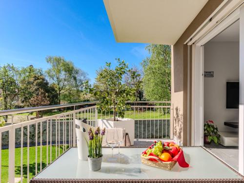 a table with a bowl of fruit on a balcony at Apartment Sunny House by Interhome in Gravedona