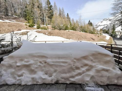 a pile of snow on the side of a fence at Apartment Giglio Apartment by Interhome in Madesimo