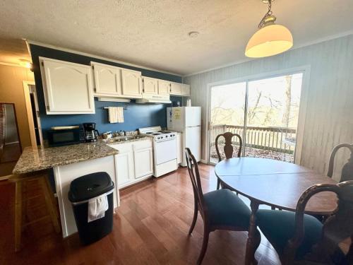 a kitchen with a table and a dining room at Cottage 12 Lees Ford Marina in Nancy