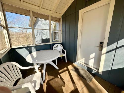 a table and chairs in a room with a window at Cottage 8Lees Ford Marina in Nancy