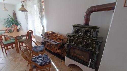 a stove in a room with a table and chairs at Penzion Duncan in Janske Lazne