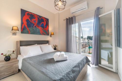 a bedroom with a bed and a large window at Tennis View Apartment in Agios Rokkos