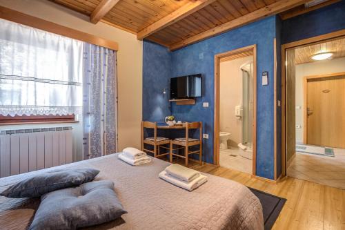 a bedroom with a large bed with a blue wall at Tourist Farm Kranjc in Kobarid