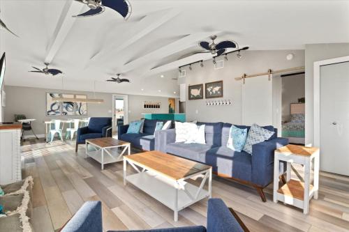 a living room with a blue couch and a table at Family Tides in Holmes Beach