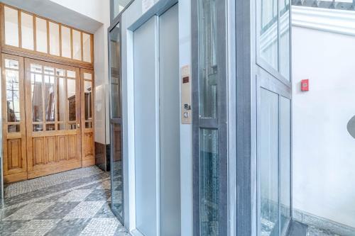 a hallway with glass doors in a building at Politecnico & Crocetta Elegant Flat in Turin