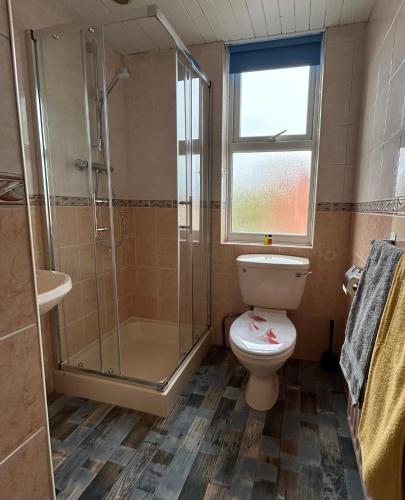 a bathroom with a toilet and a glass shower at 1 Newcastle Street in Crewe