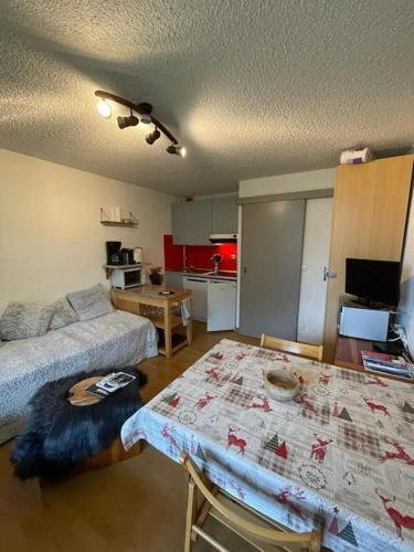 Cette chambre comprend un lit, une table et une cuisine. dans l'établissement Appart à la montagne navette et parking gratuit, à Arâches-la-Frasse