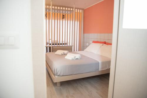 a bedroom with a bed with two towels on it at Marigold Residence in Roseto degli Abruzzi