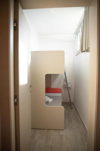 a small room with a bed and a window at Marigold Residence in Roseto degli Abruzzi