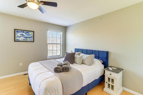 a bedroom with a blue and white bed with two cameras on it at Michigan Townhome with Smart TV 25 Mi to Detroit! in Grand View Acres