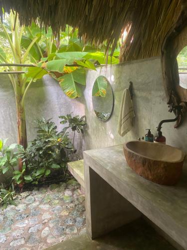 a bathroom with a wooden sink and a mirror at Agua de Luna in Isla Fuerte