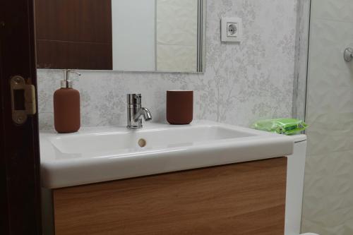 a bathroom sink with two vases on top of it at Apartamento Casa Dalí in Jerez de la Frontera
