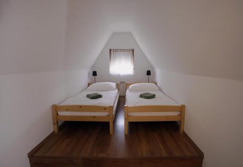 a bedroom with two beds in a attic at Villa Anita - 100 metrov od pláže Bercsényi in Balatonakarattya