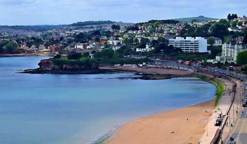 a view of a beach with a city in the background at Diamond Hotel in Torquay