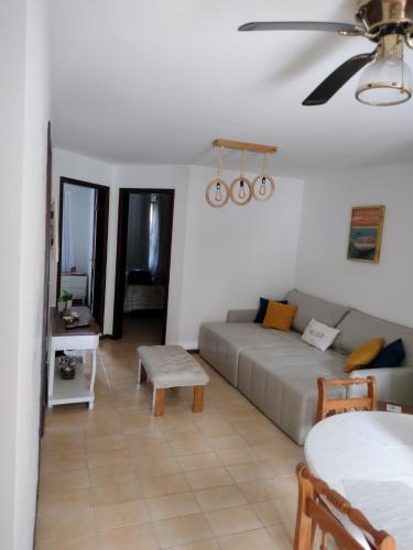 a living room with a couch and a table at Bida's House Caiobá in Matinhos