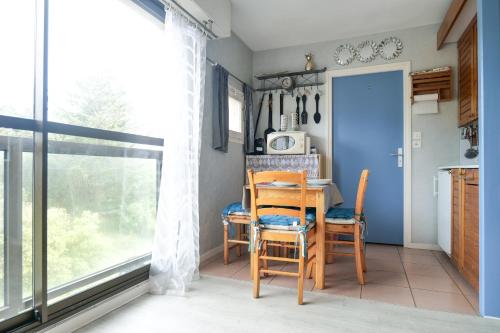 une salle à manger avec une table et des chaises et une fenêtre dans l'établissement Studio au calme quartier Port Olona Les Sables 4 personnes, à Les Sables-dʼOlonne