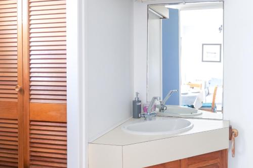 a bathroom with a sink and a mirror at Studio au calme quartier Port Olona Les Sables 4 personnes in Les Sables-dʼOlonne