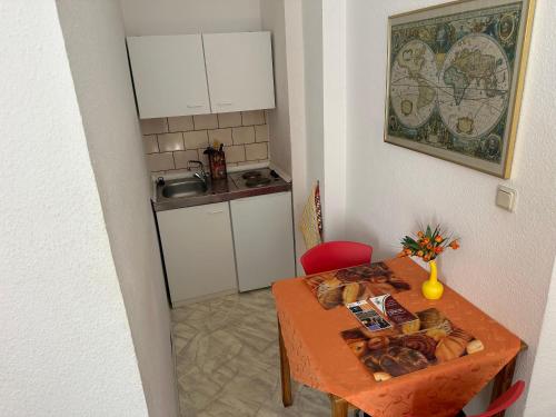 a small kitchen with a table with bread on it at Die kleine Pension in Delmenhorst