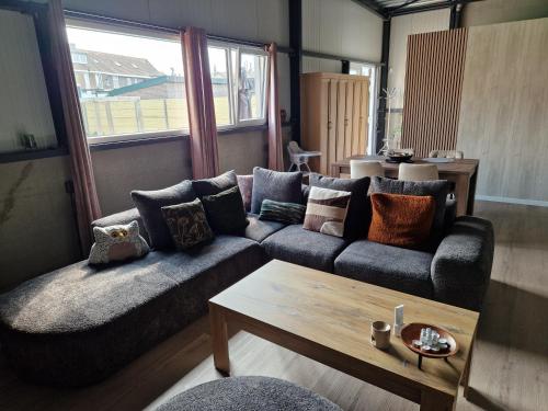 a living room with a couch and a coffee table at Klein duimpje in Echt
