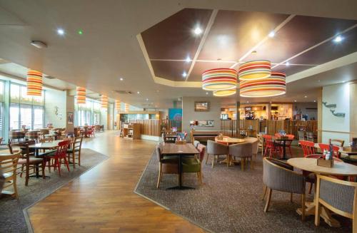 a dining room with tables and chairs and a restaurant at Caravan by Camber Sands in Camber