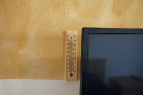 a ruler on a wall next to a computer monitor at Cazare Alfredo in Craiova