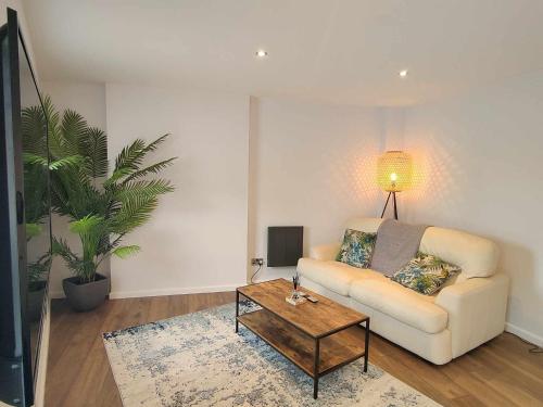a living room with a couch and a coffee table at Queen's Apartment in Cardigan, Cardigan Bay in Cardigan
