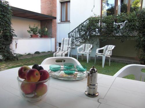 a table with a bowl of fruit on top of it at B&B Castellani in Venice-Lido
